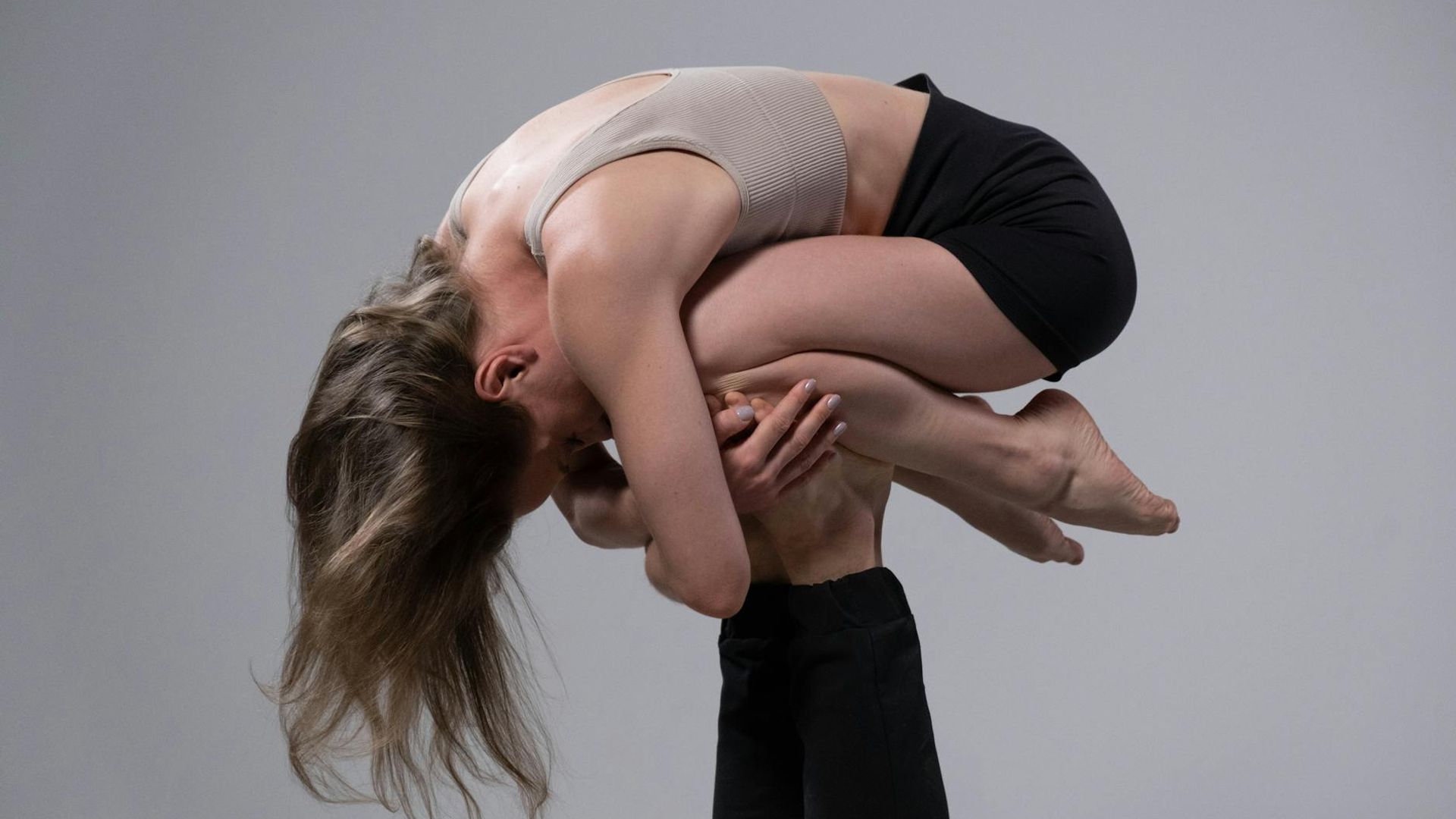 Man performing a foundational strength exercise in a minimalist environment.